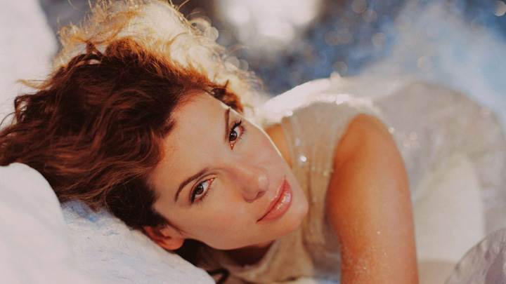 Sandra Bullock Laying Pose In White Dress Looking Front Photoshoot
